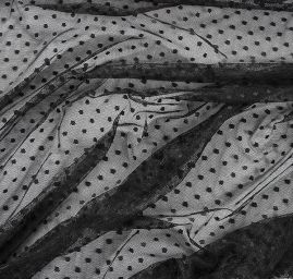 Pružný tyl s vyšitými puntíky v černé barvě