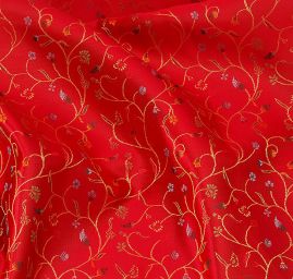 Látka brokát květy na červeném podkladě