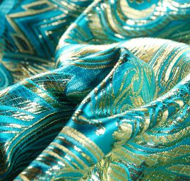 Efektní brokát hlavicový vzor zlatotyrkysový
