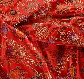 Látka brokát červeným se zlatým orientálním motivem 