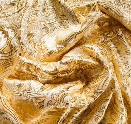 Efektní brokát hlavicový vzor zlato žluté barvy