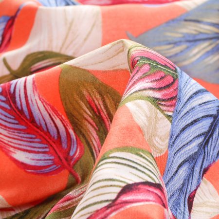 Viskozová šatová látka listy světle oranžová