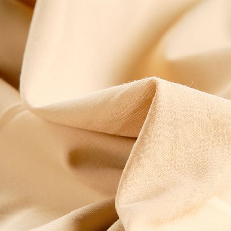 Kostýmová látka pískově žluté barvy