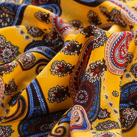 Viskozová šatová látka tisk paisley vzor modrožlutá
